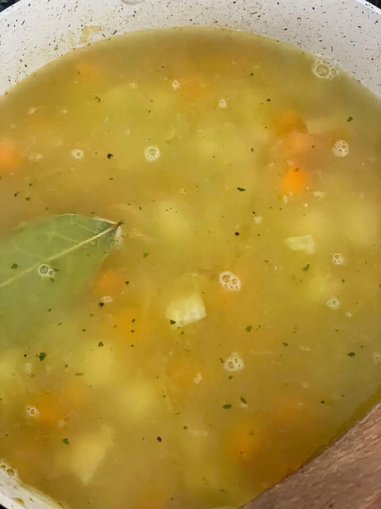 Hot veggie stock poured into soup pot.