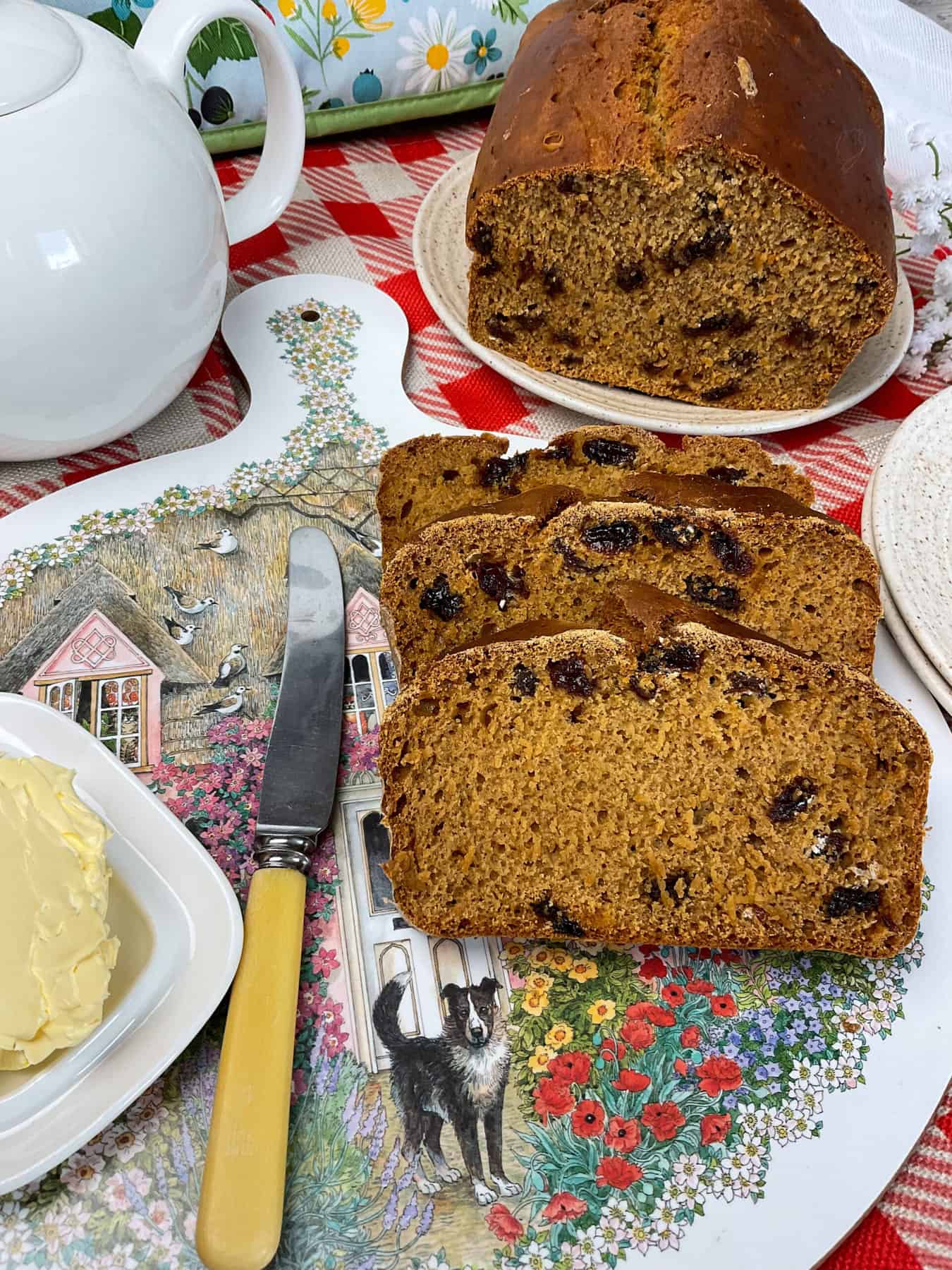 Tea table set with slices of malt loaf and teapot.