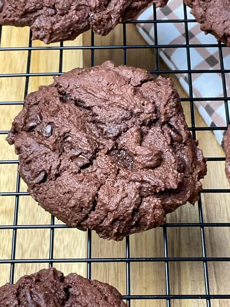Double chocolate chip cookies cooling on a wire rack.