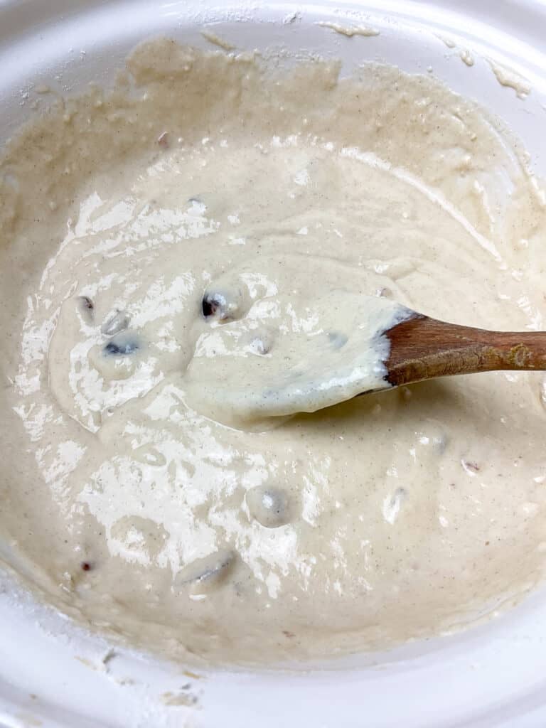 Soya milk added to cherry loaf ingredients in mixing bowl.