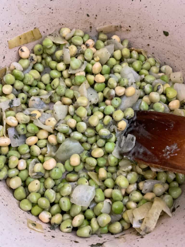 peas added to onion mixture in soup pot.