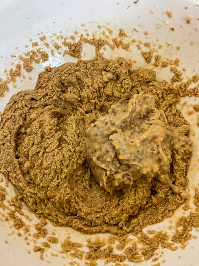 peanut butter added to creamed ingredients in mixing bowl for old-fashioned peanut butter cookies.