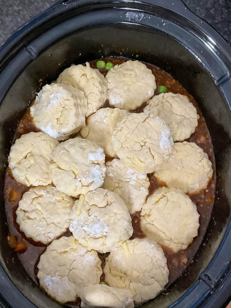cobbler scones added to top of the savoury mince in the slow cooker. 