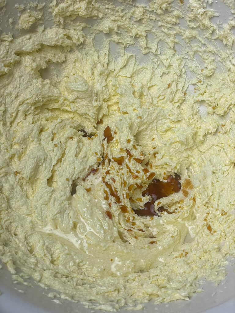 vanilla and almond essence added to creamed margarine.