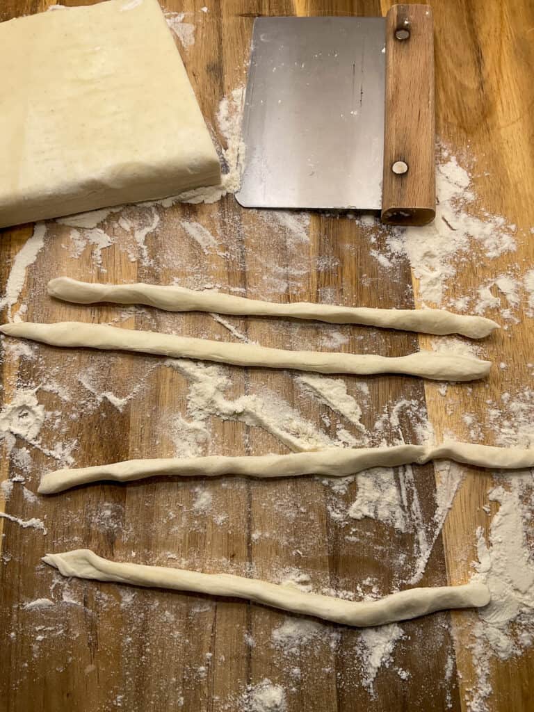 puff pastry rolled into thin long pieces for pie crust rim.