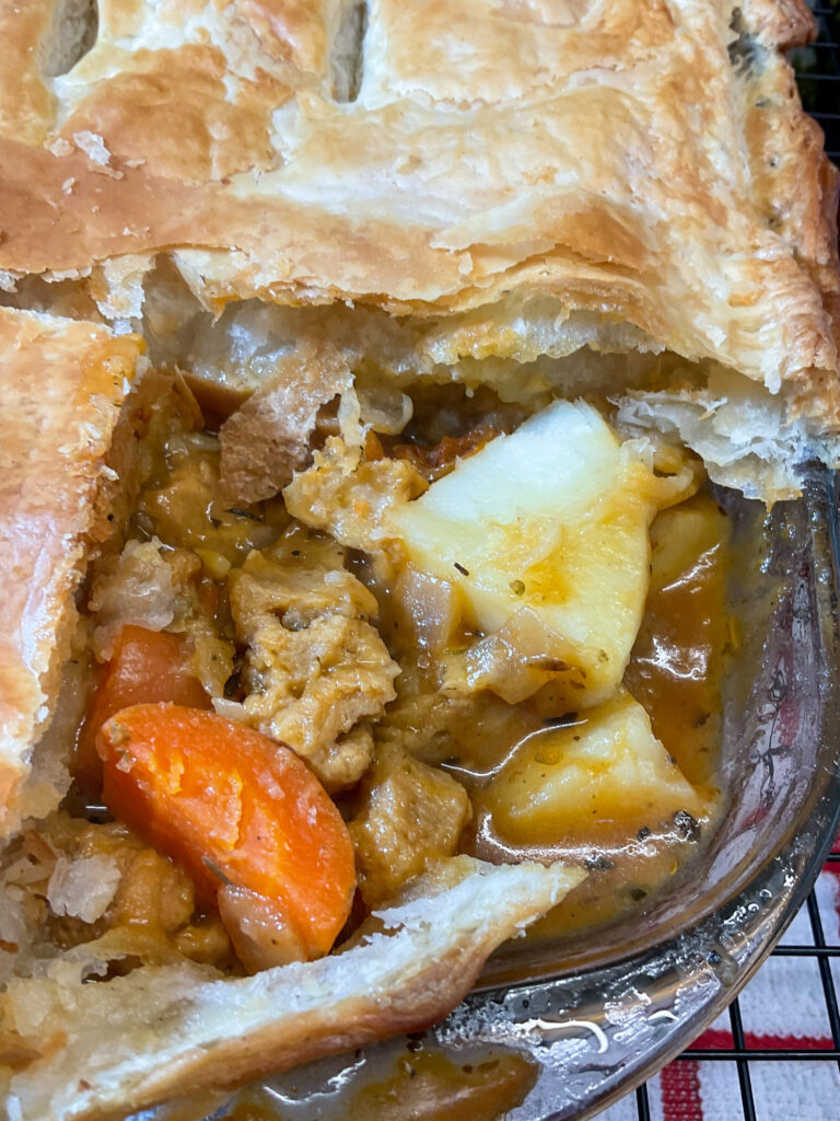 meat and potato pie with pastry removed to show the inside filling.
