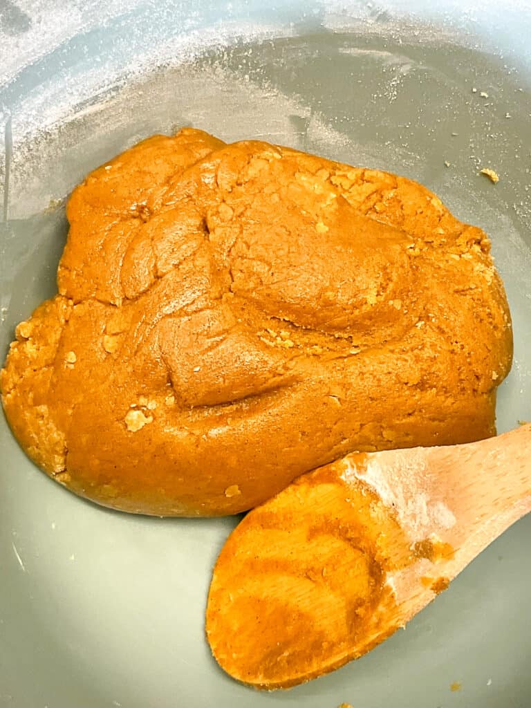 gingerbread men ingredients mixed into a cookie dough ball.