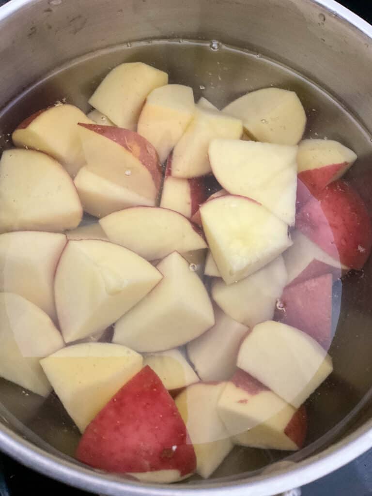 Potato chunks in saucepan ready to cook for homity pie filling.