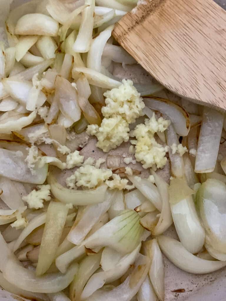 Onions cooked and minced garlic added to fry pan.