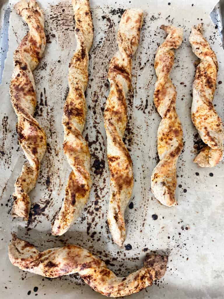 Baked breadsticks on baking tray.