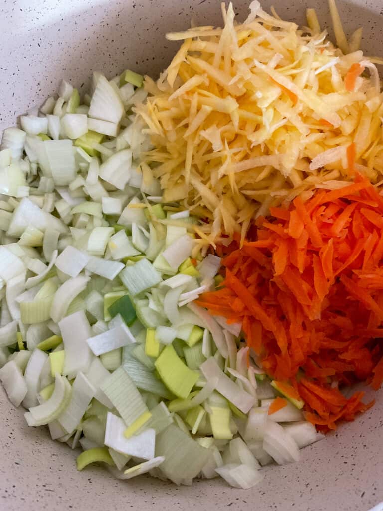 Fresh veggies added to soup pot to saute for Orcadian oatmeal soup.