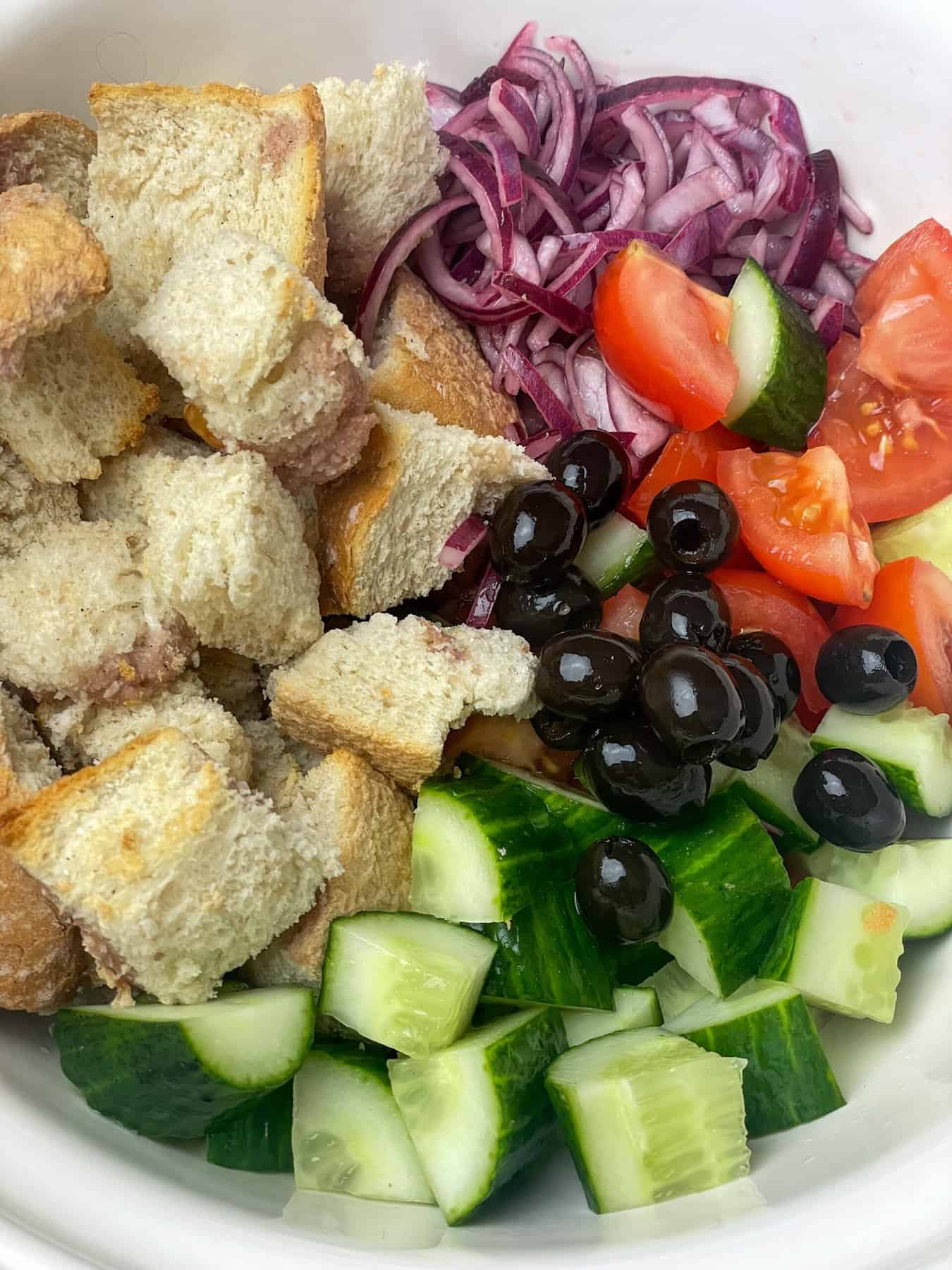 Panzanella ingredients in bowl.