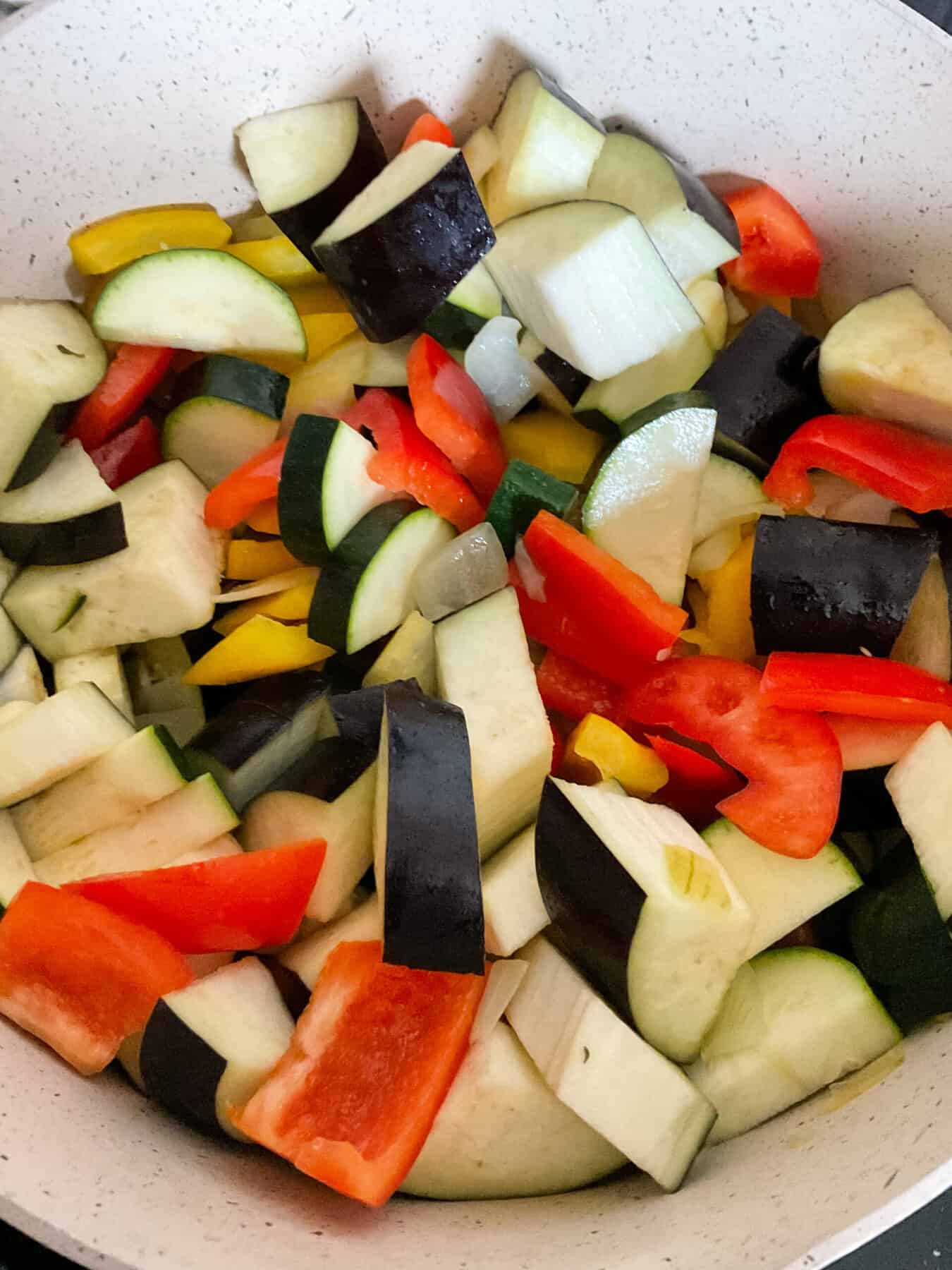 Veggies stirred together in stew pot.