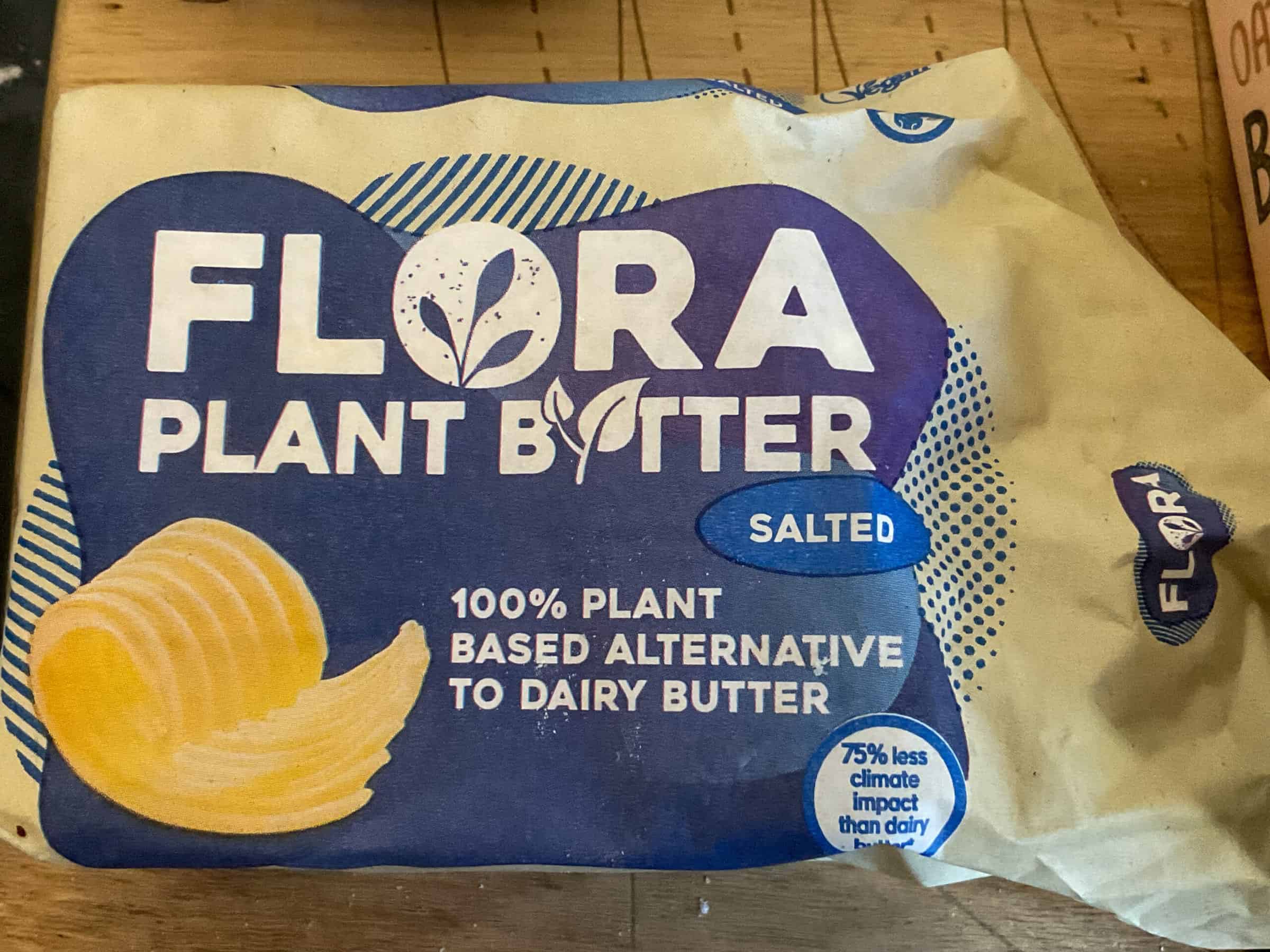 Flora butter for macaroni cheese on a wooden board.