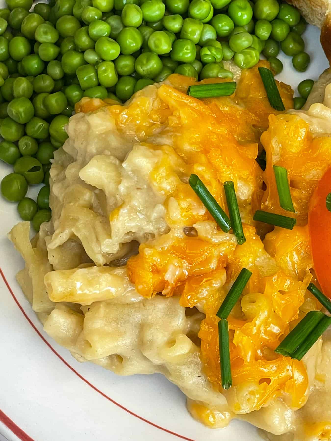 A close up view of macaroni cheese, the side of the plate.