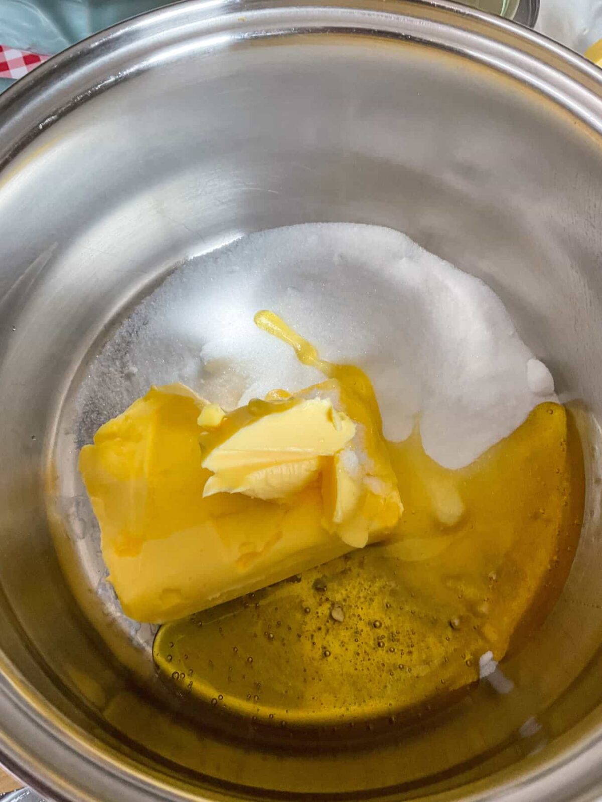 Margarine, syrup and sugar melting in saucepan.