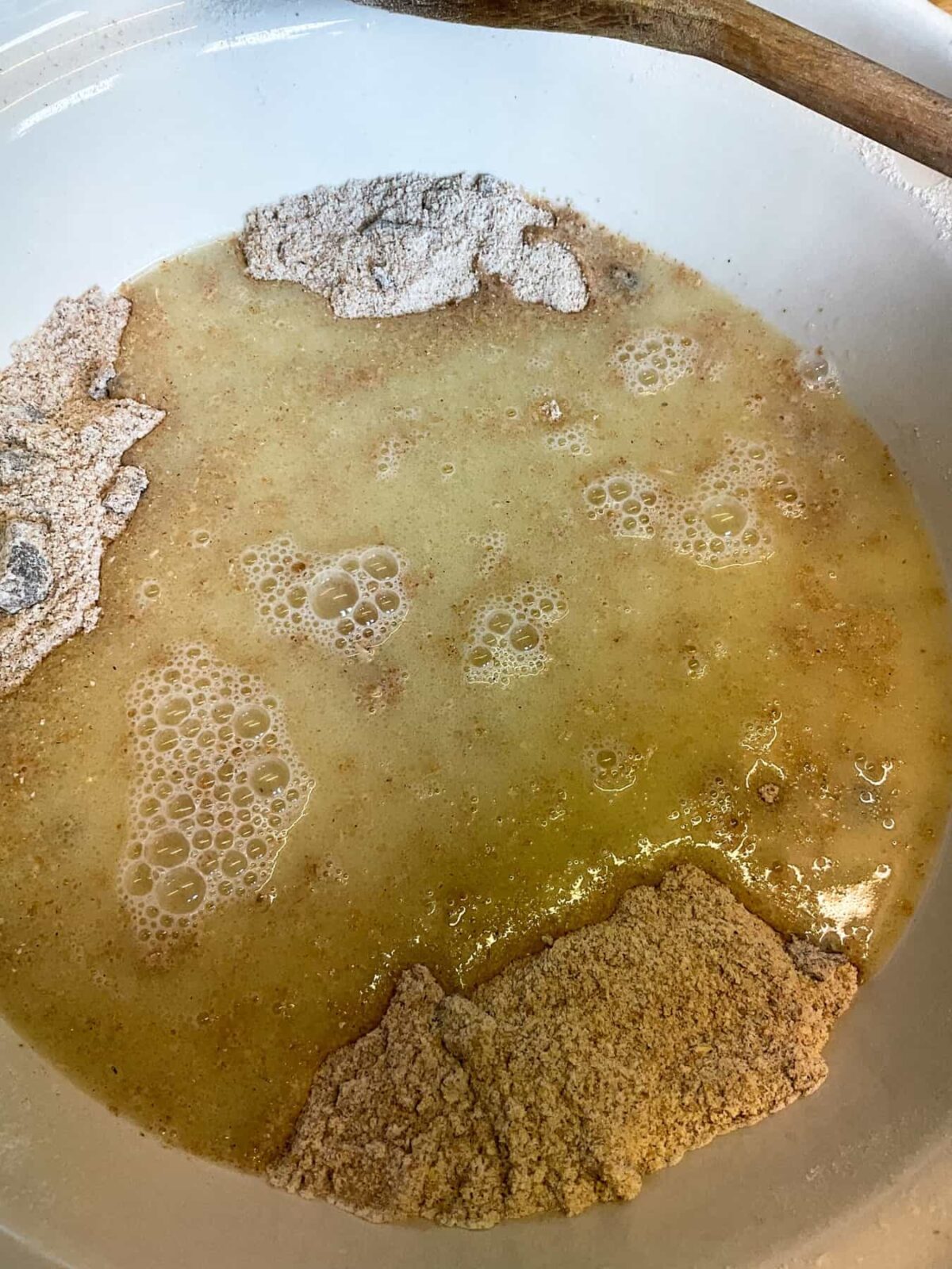 Buttermilk mixed with apple sauce and oil, and poured into mixing bowl with dry ingredients.