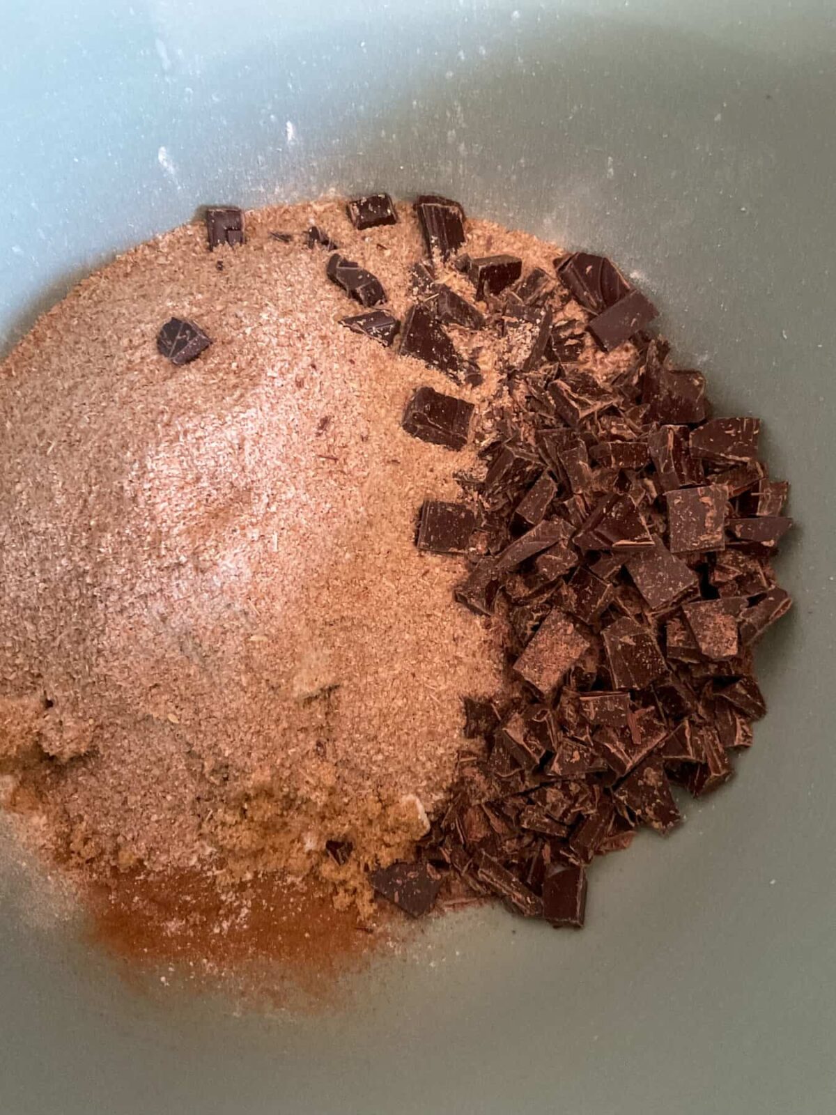 Chocolate chips and bran in bowl for chocolate chip muffins.