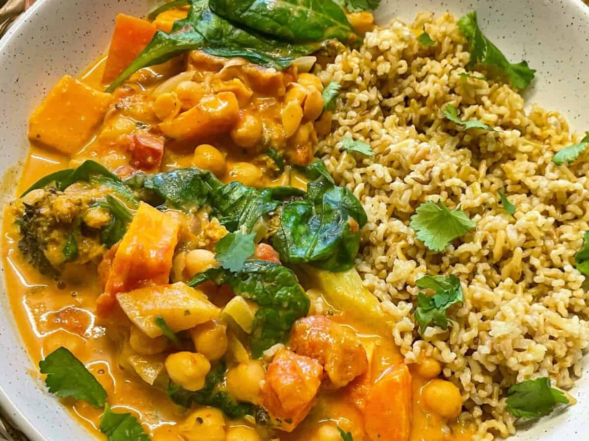 Red Thai curry served with brown rice and a coriander garnish.