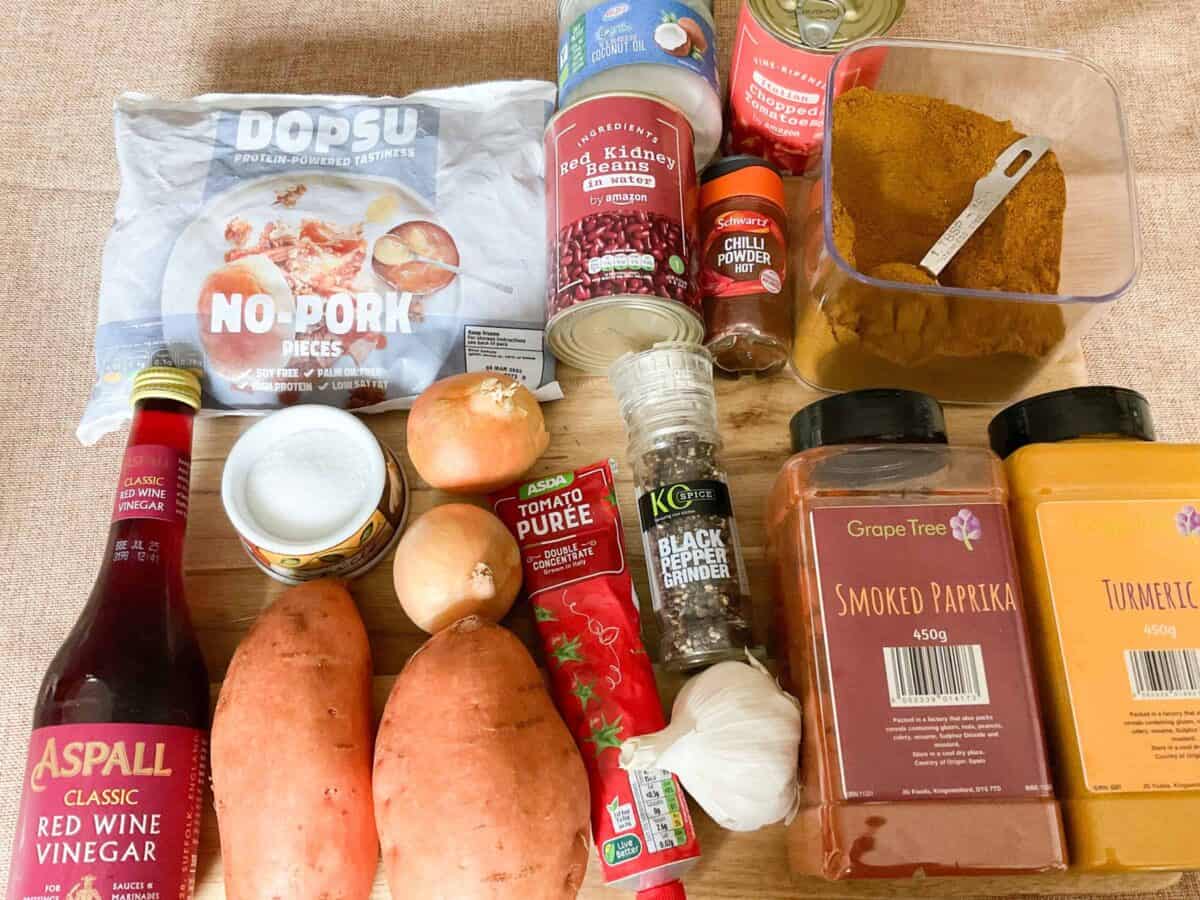 Ingredients for vindaloo on wooden cutting board.