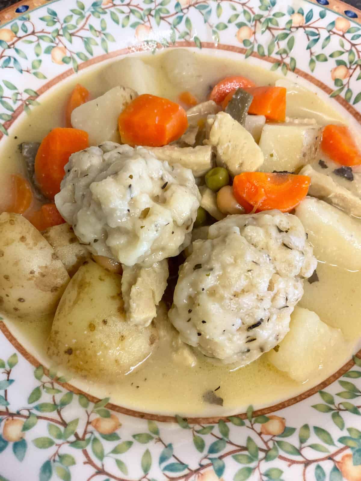 Bowl of vegan chicken stew served with dumplings, close up.