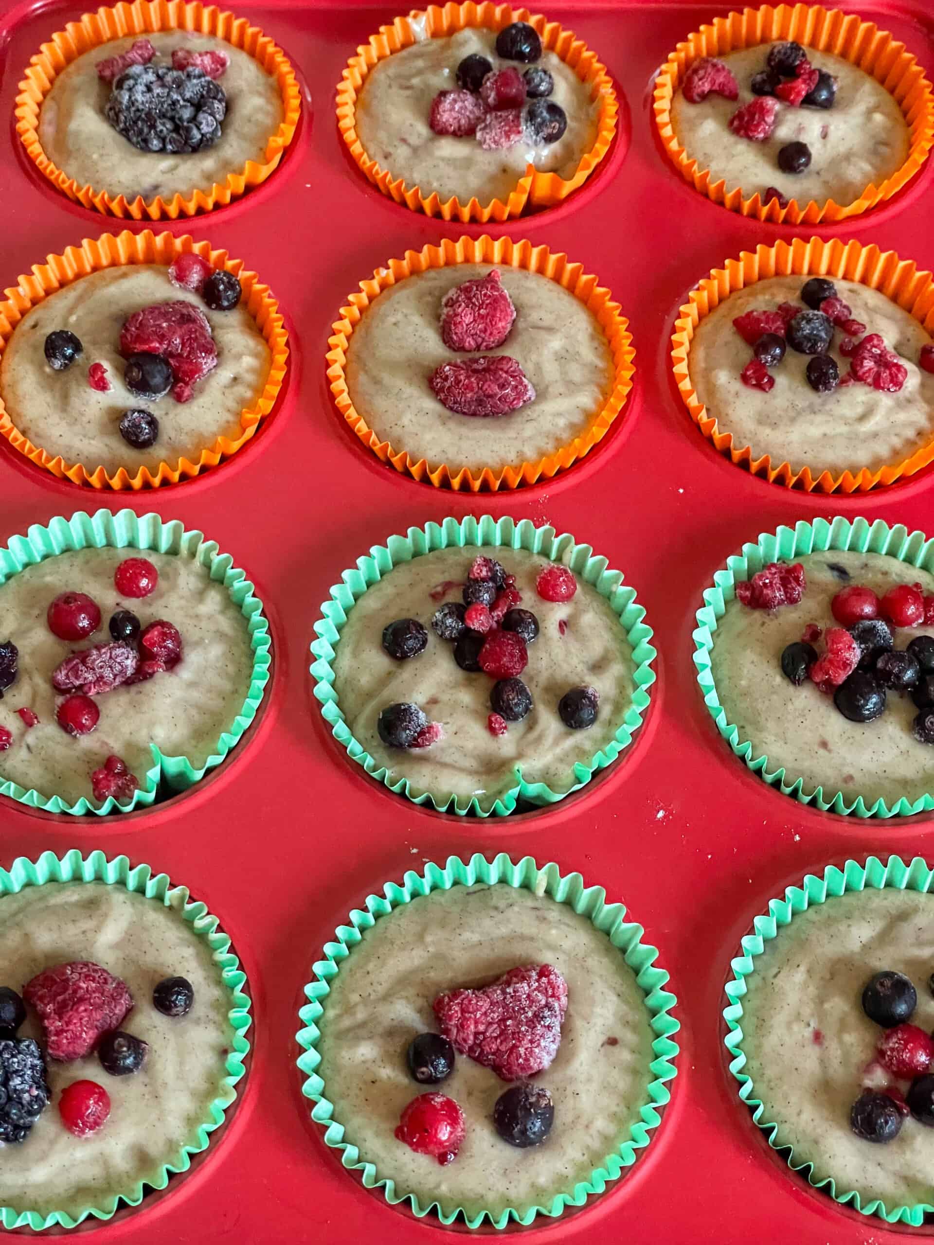Extra mixed berries scattered over top of muffins.