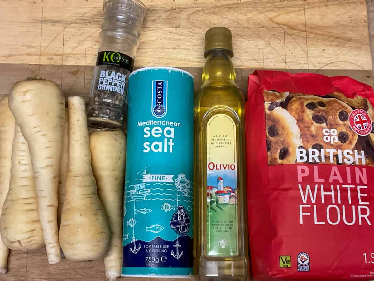 Ingredients for parsnip patties on a wooden cutting board.