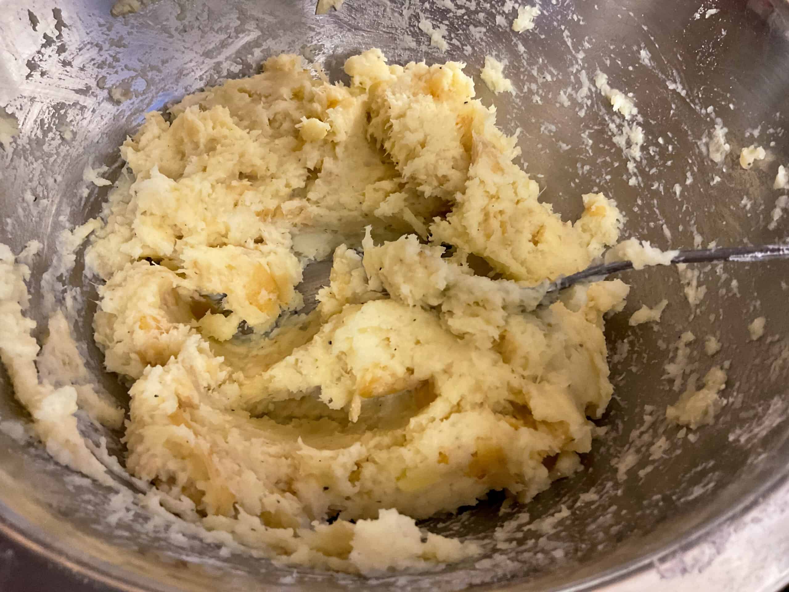 Parsnips mashed and seasoning mixed through ready to make into patties.