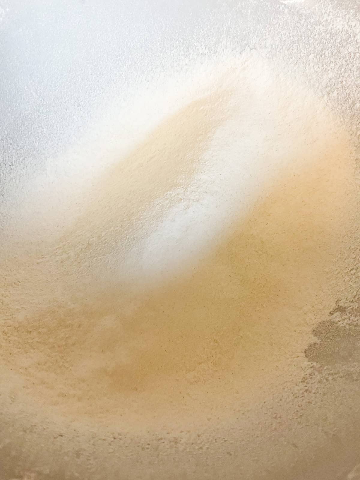 A mixing bowl with flour and baking powder.