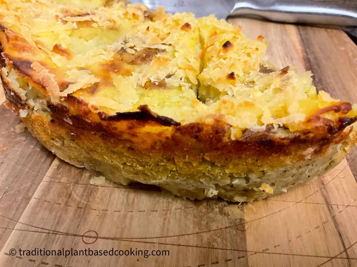Old-fashioned lentil pie slices on chopping board.