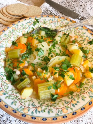 Winter vegetable pottage served in bowl with oatcakes.