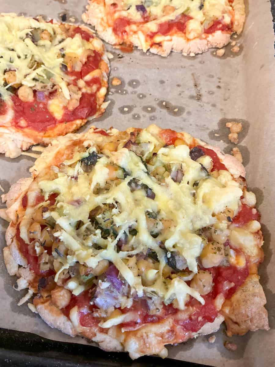 Scone base pizza cooked on baking tray.