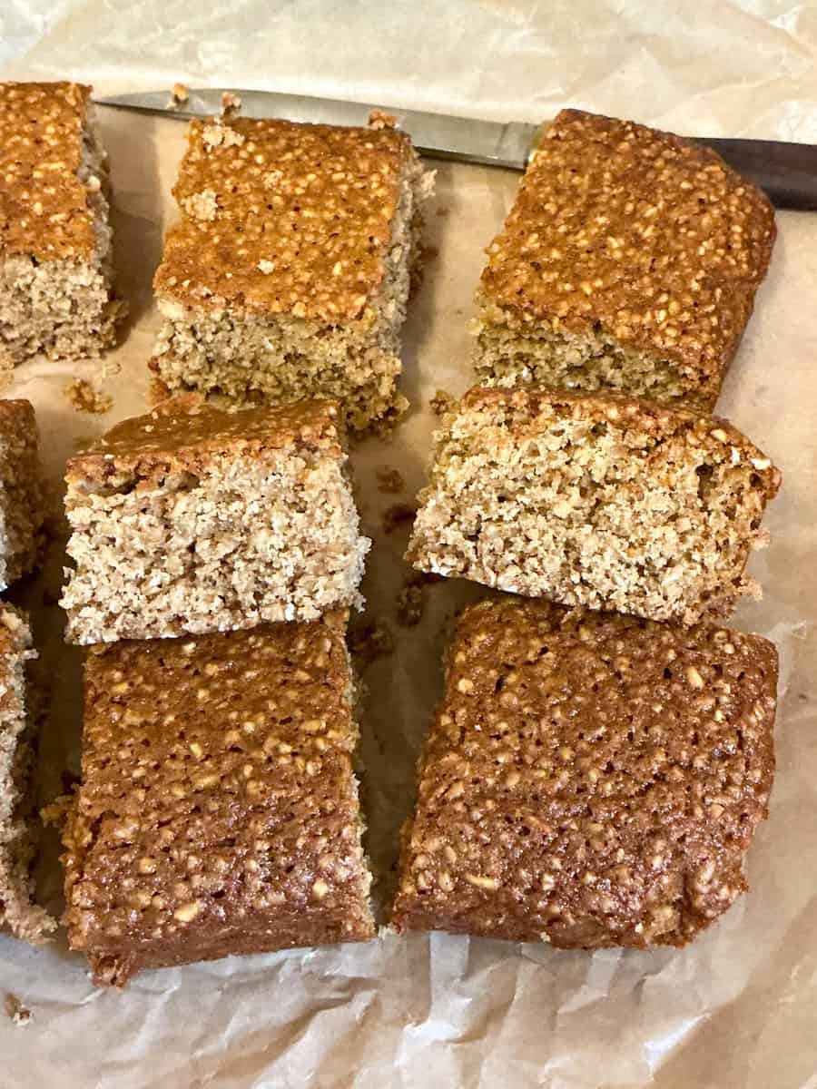 Vegan parkin cake sliced into squares.