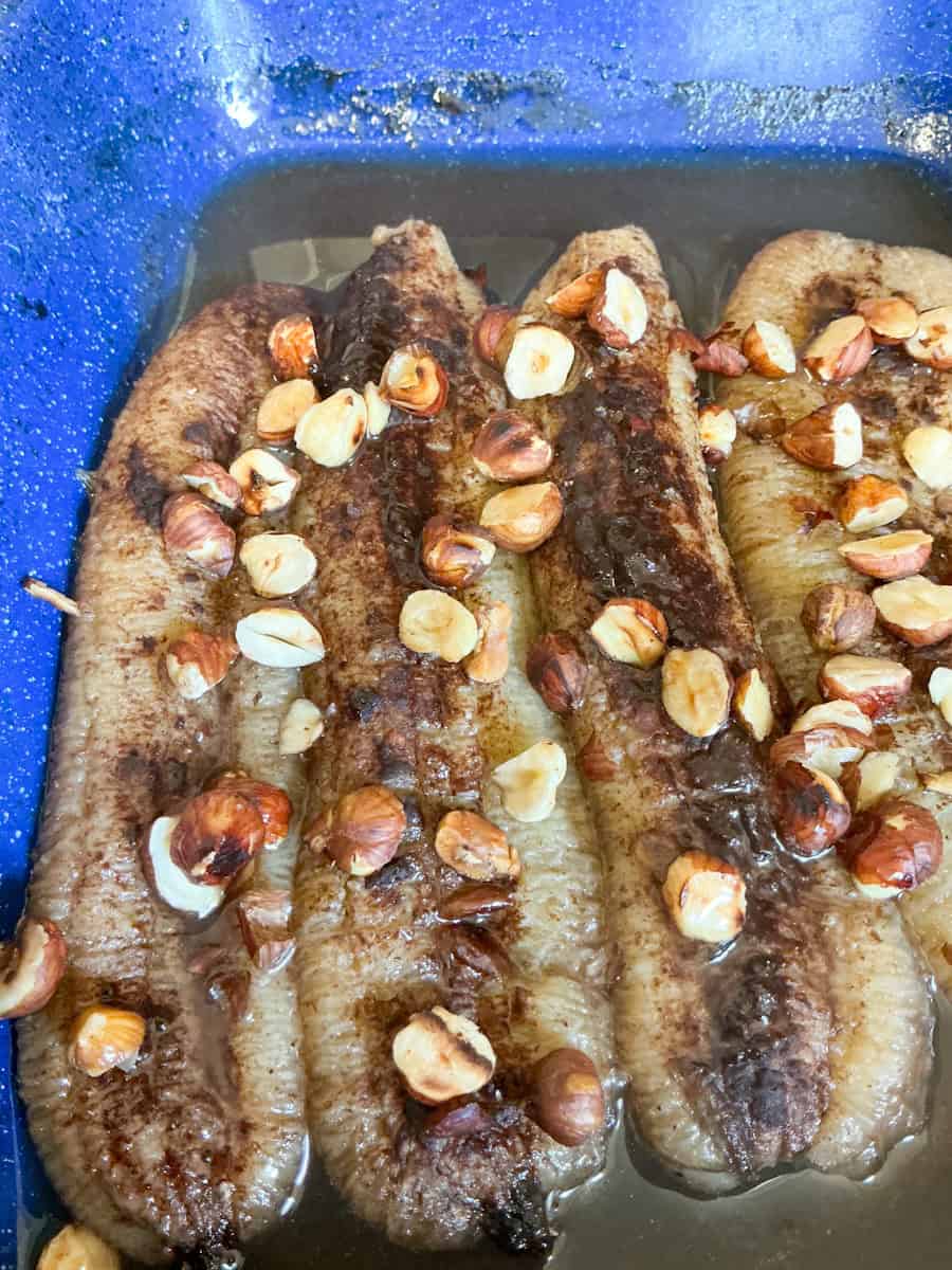 Vegan honey baked bananas in blue baking pan.