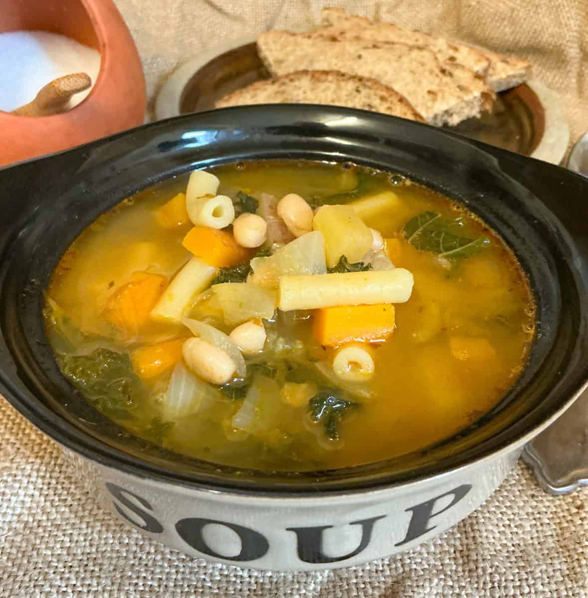 Vegan Minestrone soup served in small bowl with the text 'soup' on it.