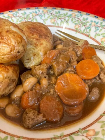 A bowl of vegan Guy Fawkes Stew served with baked potatoes, featured image.