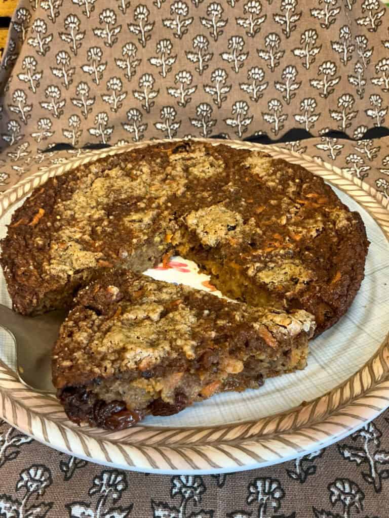 Baked pudding on serving bowl with a slice cut on serving spoon.
