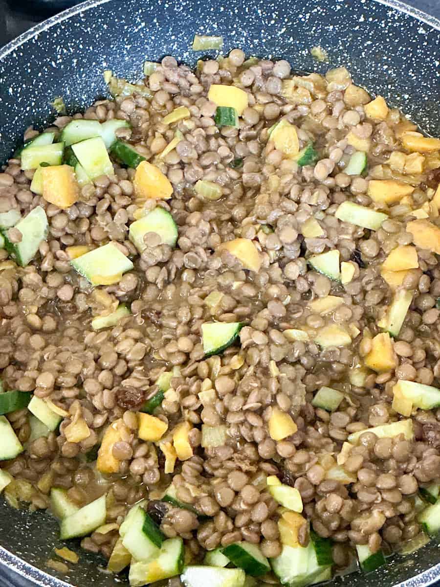 all ingredients for curry stirred together in frying pan