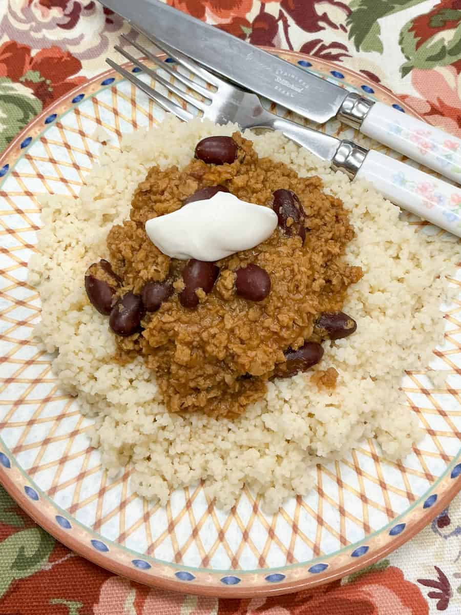 Beanfeast chilli served on plate with couscous.