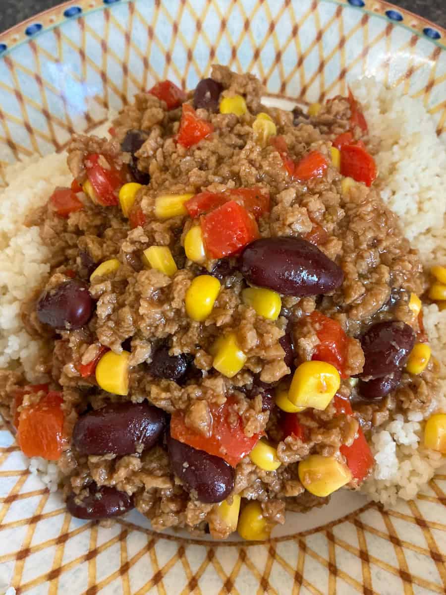 Variation beanfeast chilli served in bowl with couscous.